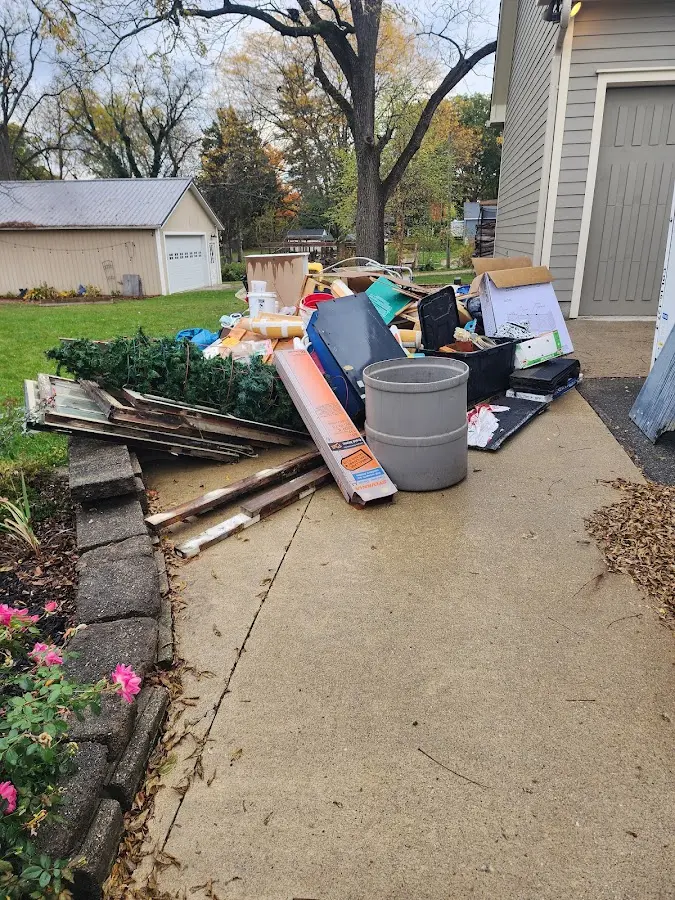 Dumpster being loaded with debris for Estate Cleanout Dumpster Rental in Clarksville